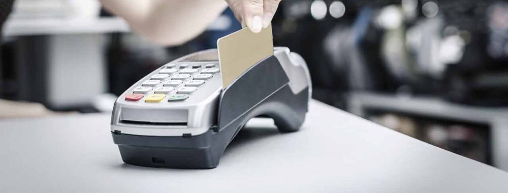 Hand holding  bank terminal and plastic card